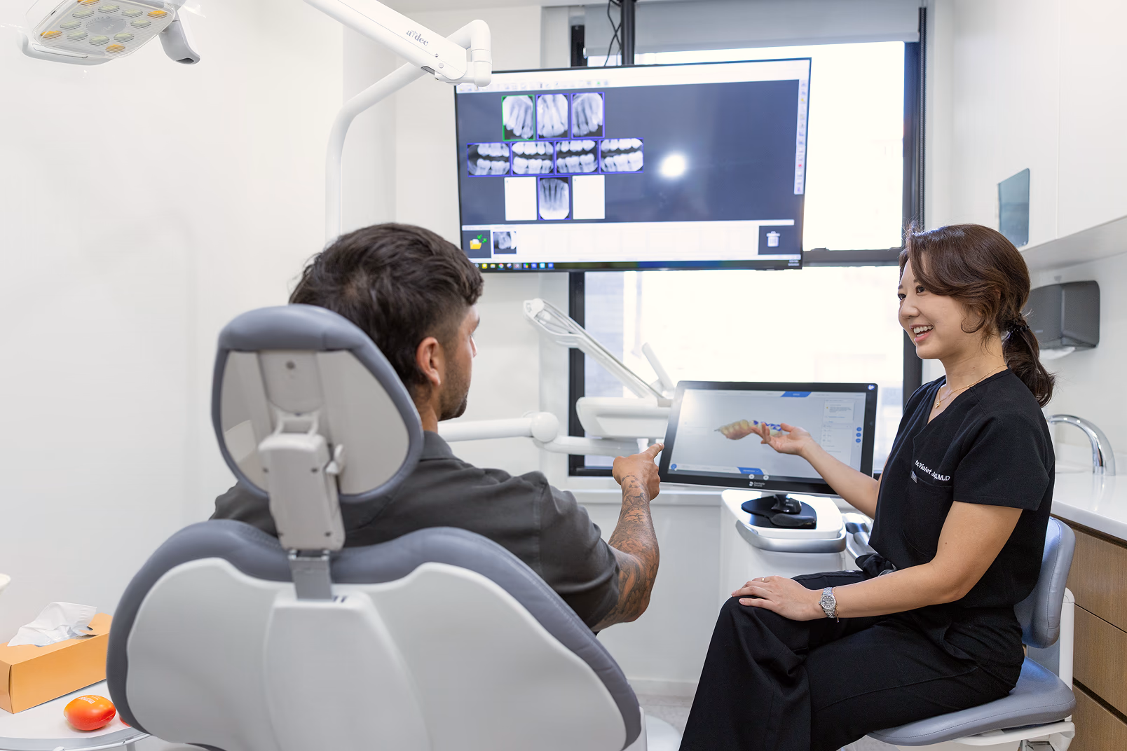 Dr. Jang reviewing digital scans with a patient